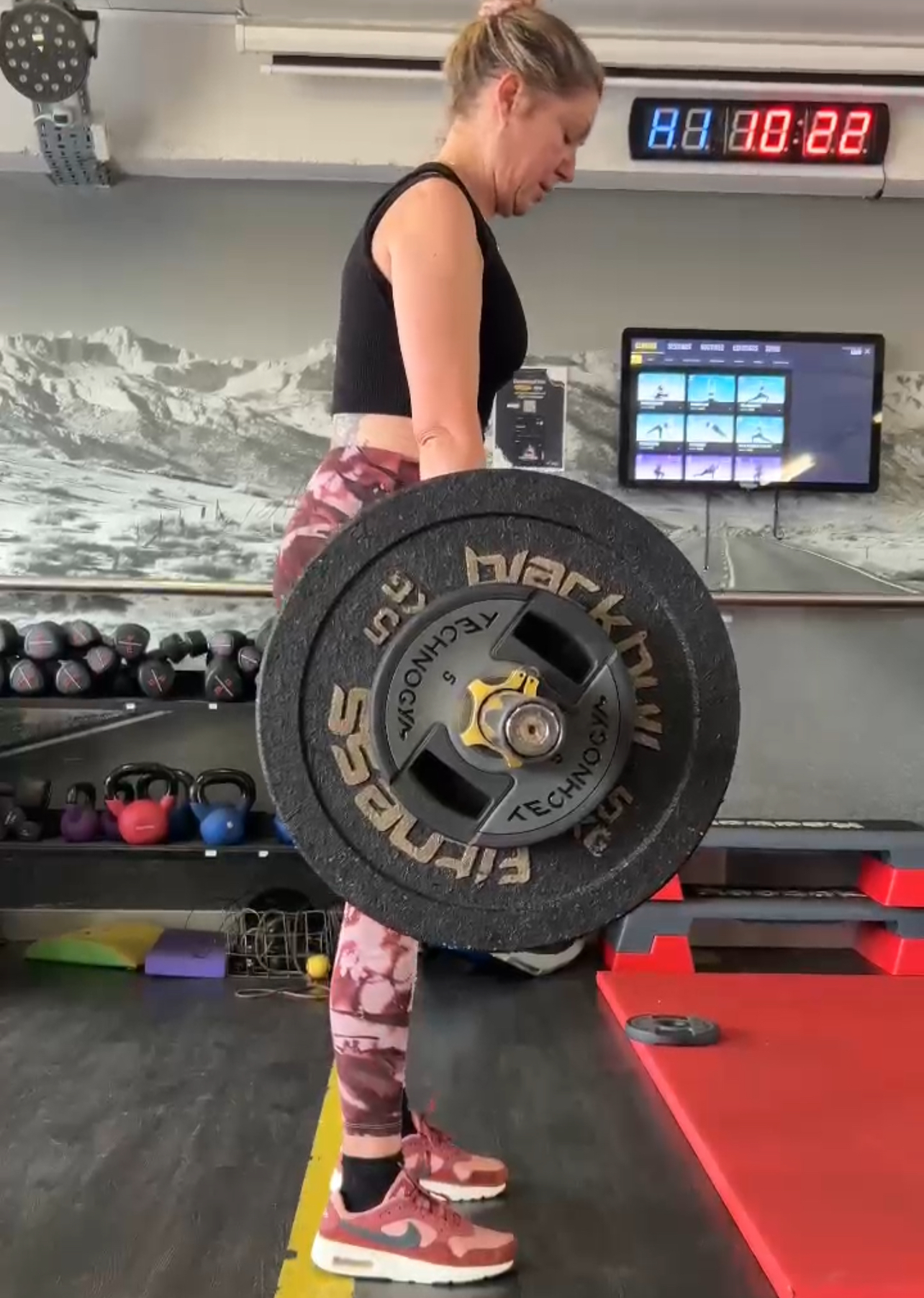 Woman lifting a barbell in the gym